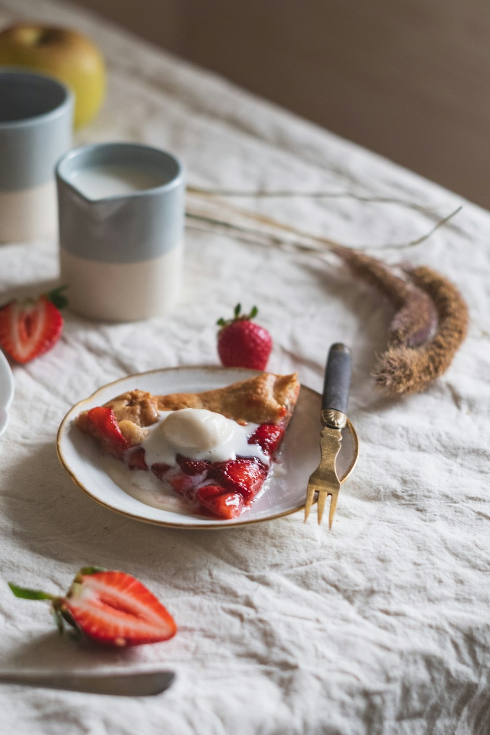 sliced bread on white ceramic plate beside stainless steel fork and knife