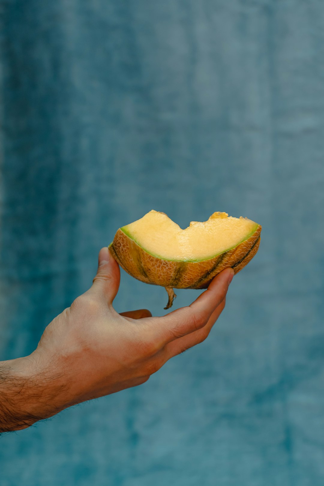person holding yellow sliced fruit