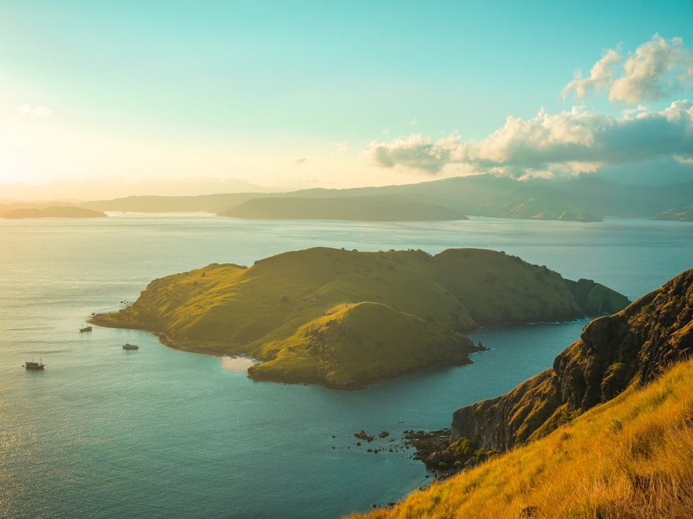 brown and green island under blue sky during daytime