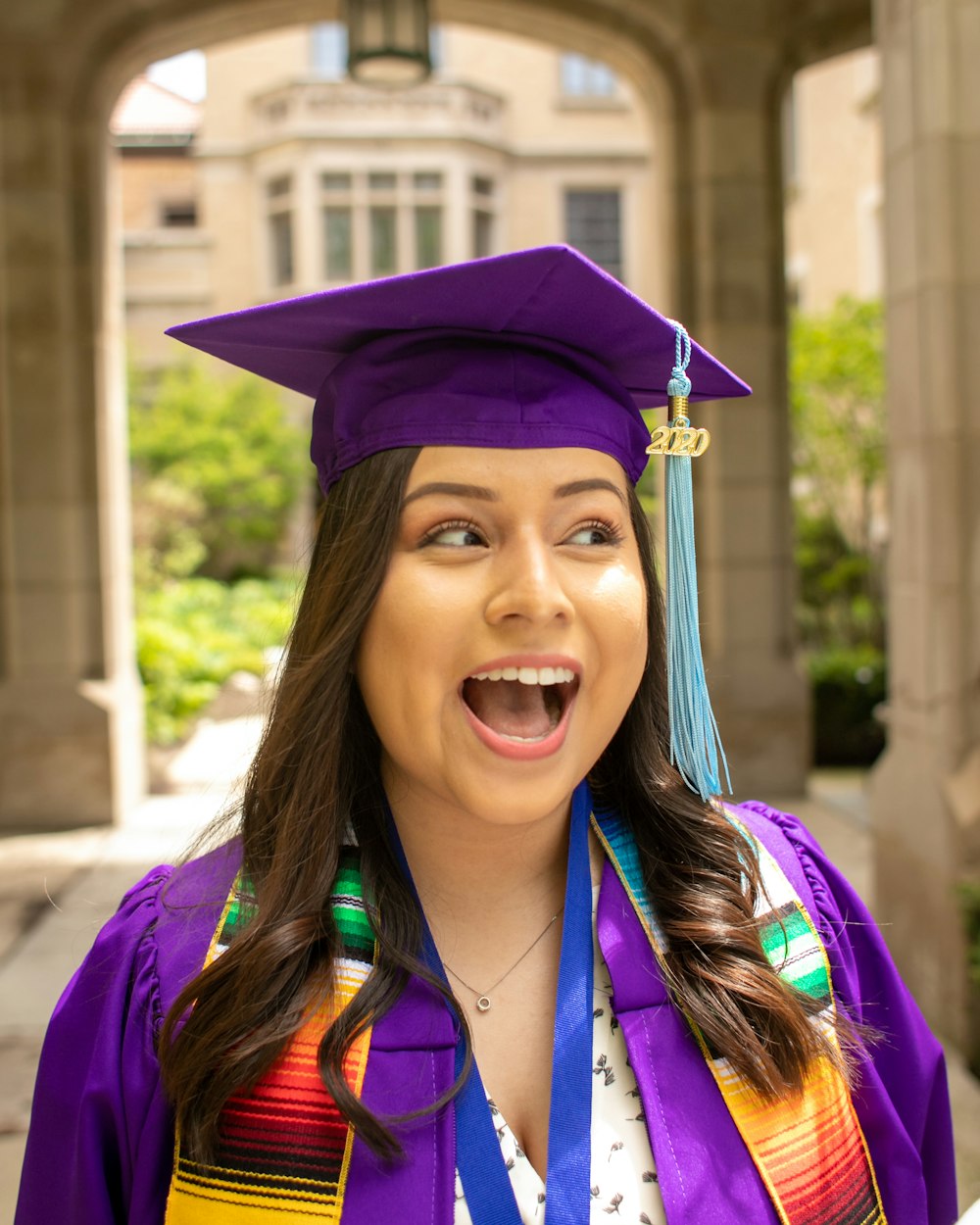 woman in blue academic dress wearing blue academic hat