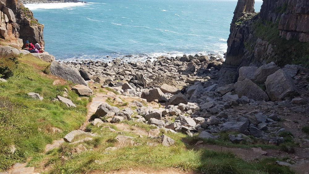gray rocks near body of water during daytime