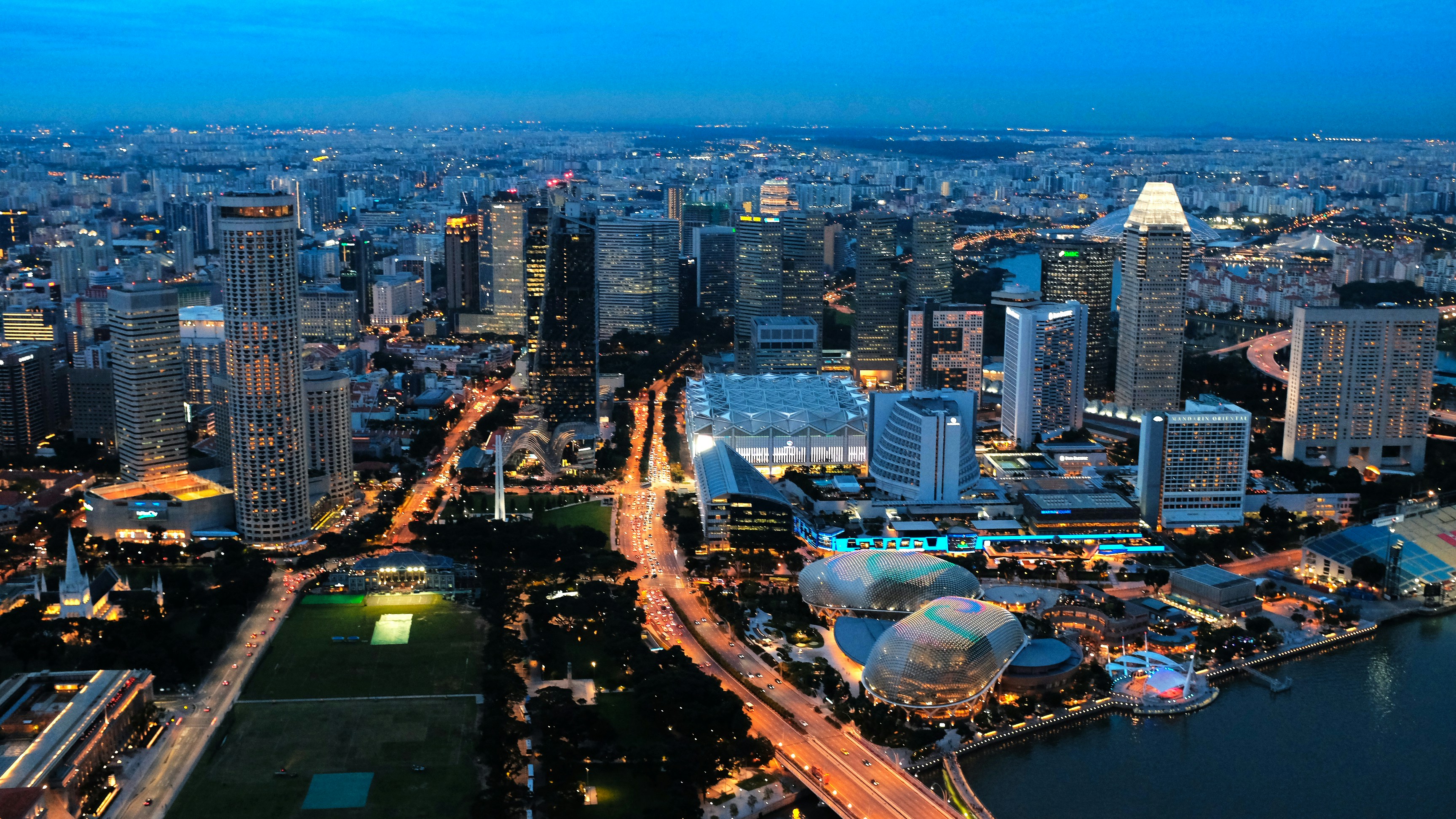 city with high rise buildings during night time, Spectacular Sunset shot of Esplanade Futuristic waterfront arts venue and Downtown landscape of Singapore.</p><p>View from Above (1-Altitude Bar)