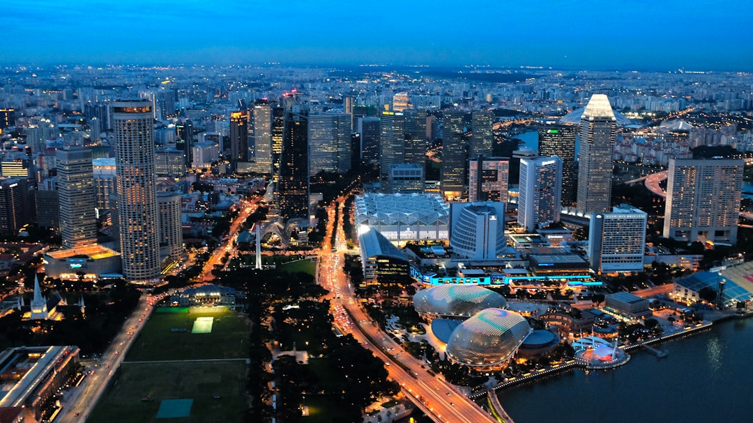 city with high rise buildings during night time, Spectacular Sunset shot of Esplanade Futuristic waterfront arts venue and Downtown landscape of Singapore.<p></figure>View from Above (1-Altitude Bar)