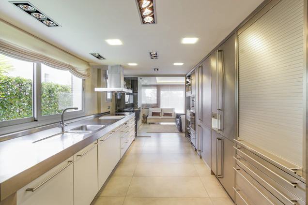 white wooden kitchen cabinet near window