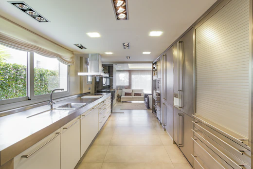 white wooden kitchen cabinet near window