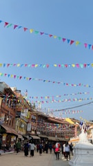 Colorful banners fluttering outside a bustling local shop in Theni.