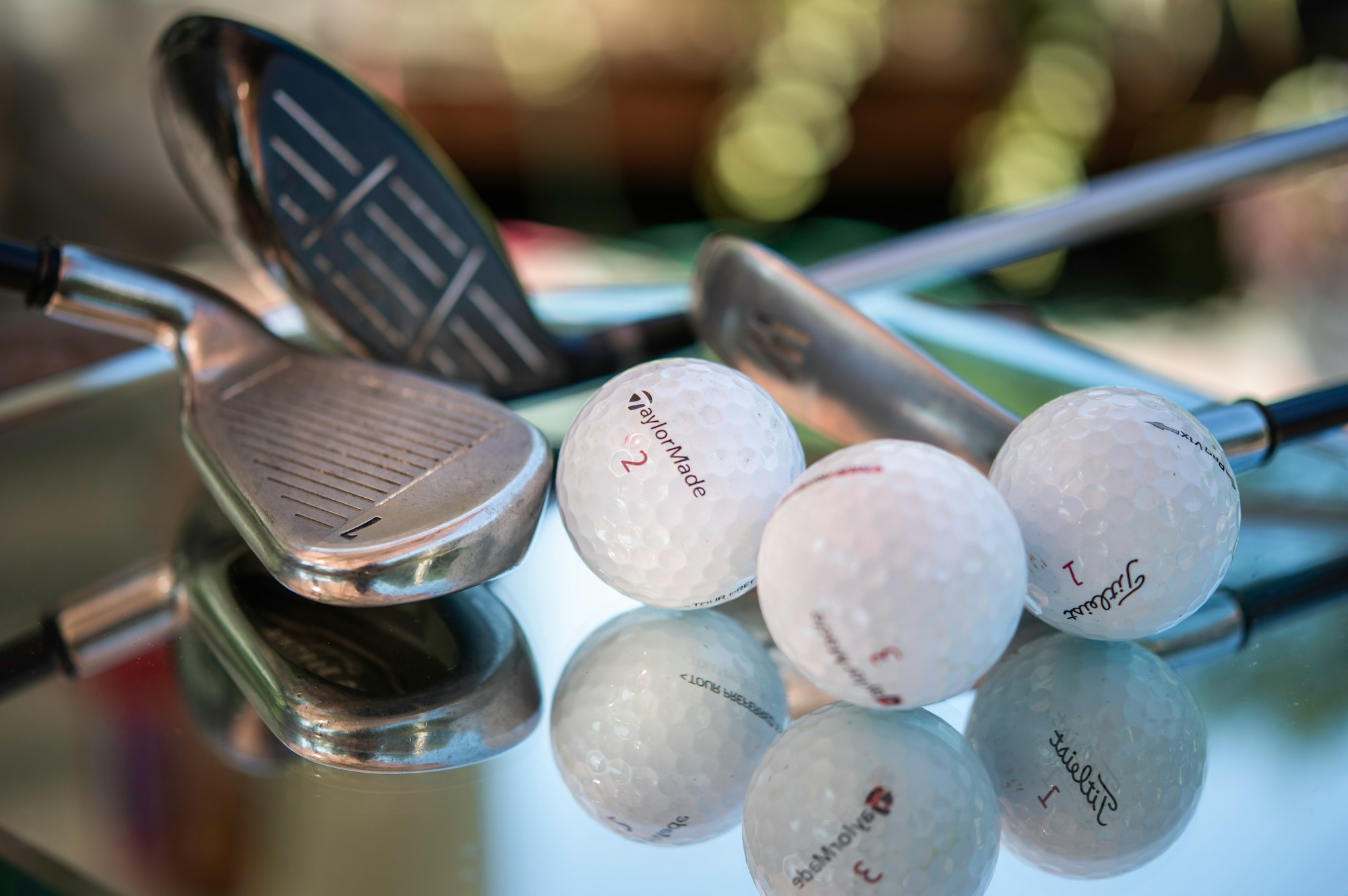 assortment of golf balls and clubs