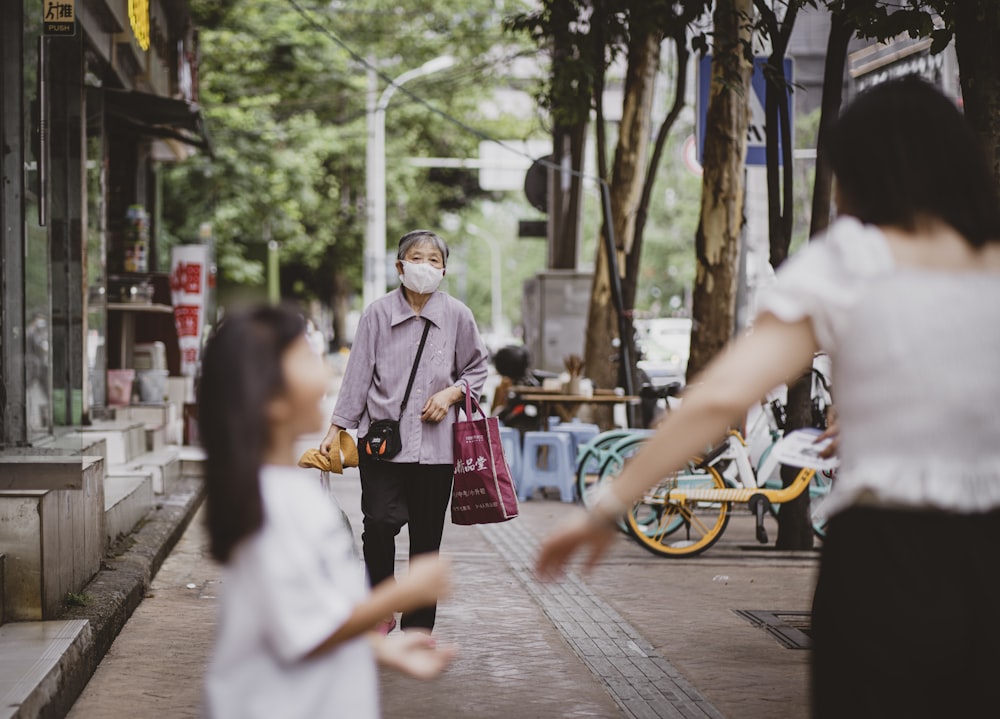 man in white thobe holding red paper bag