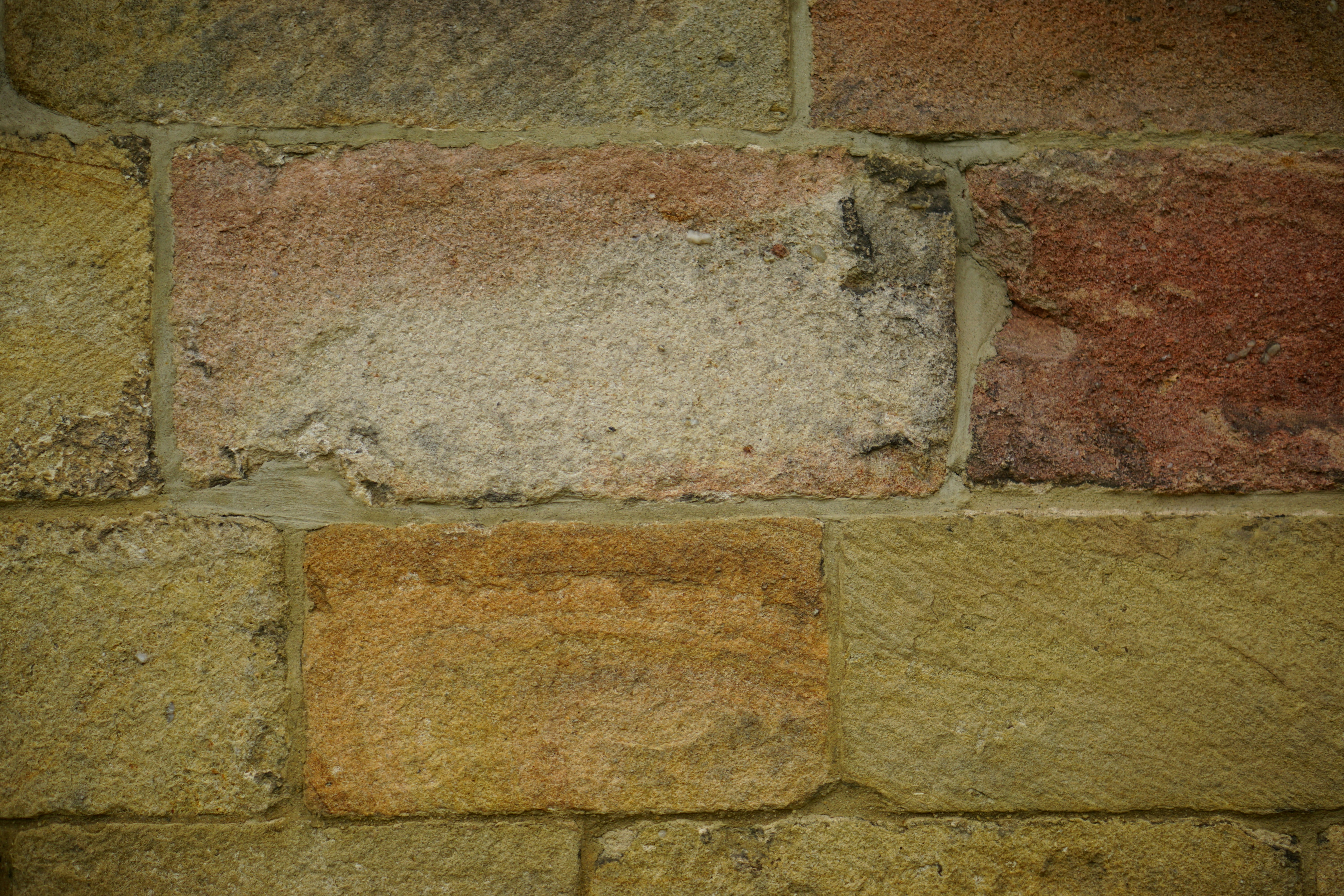 Dimension stone blocks in quarry, large rectangular cut stone, grey and brown tones, architectural quality