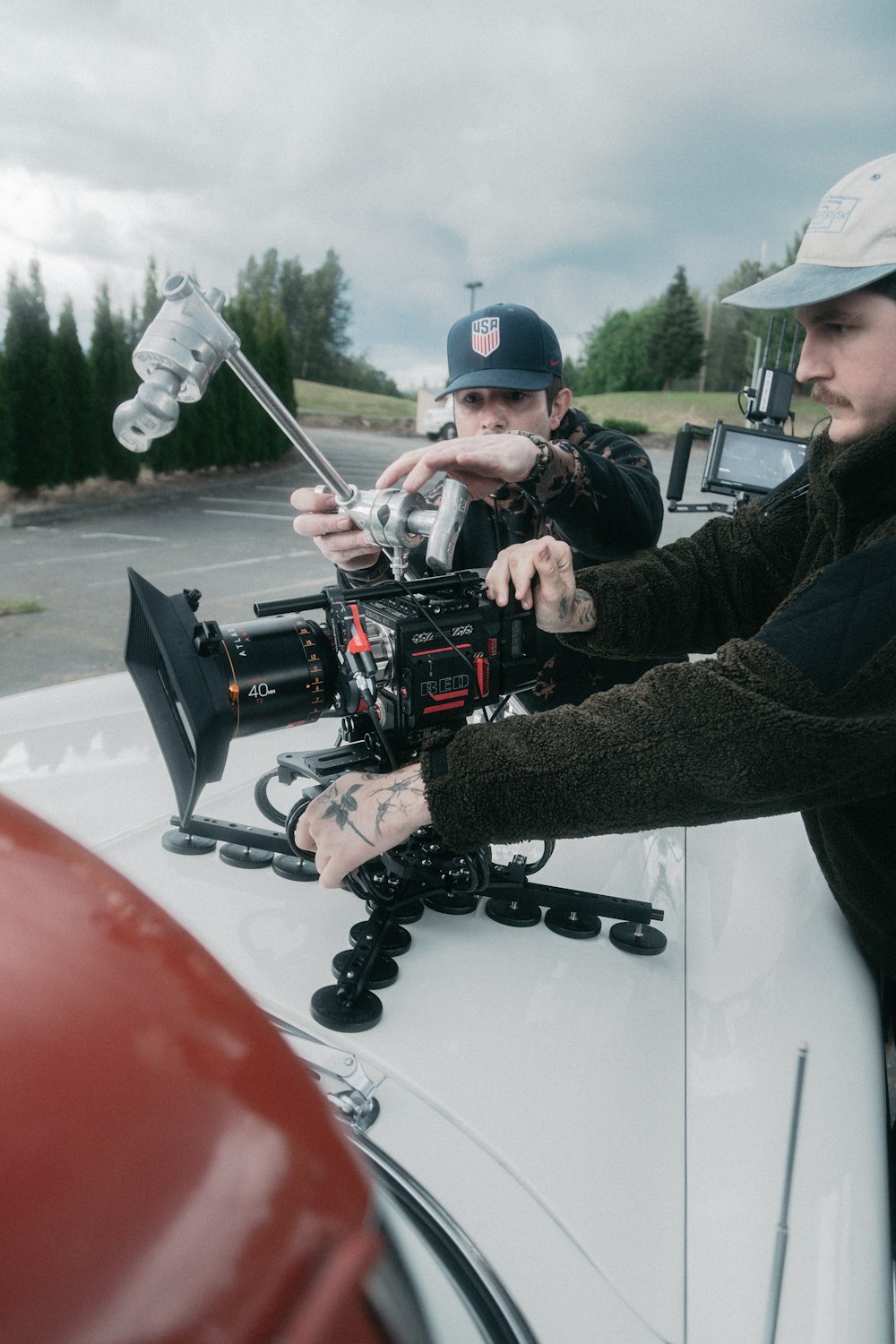 man in black jacket holding black video camera