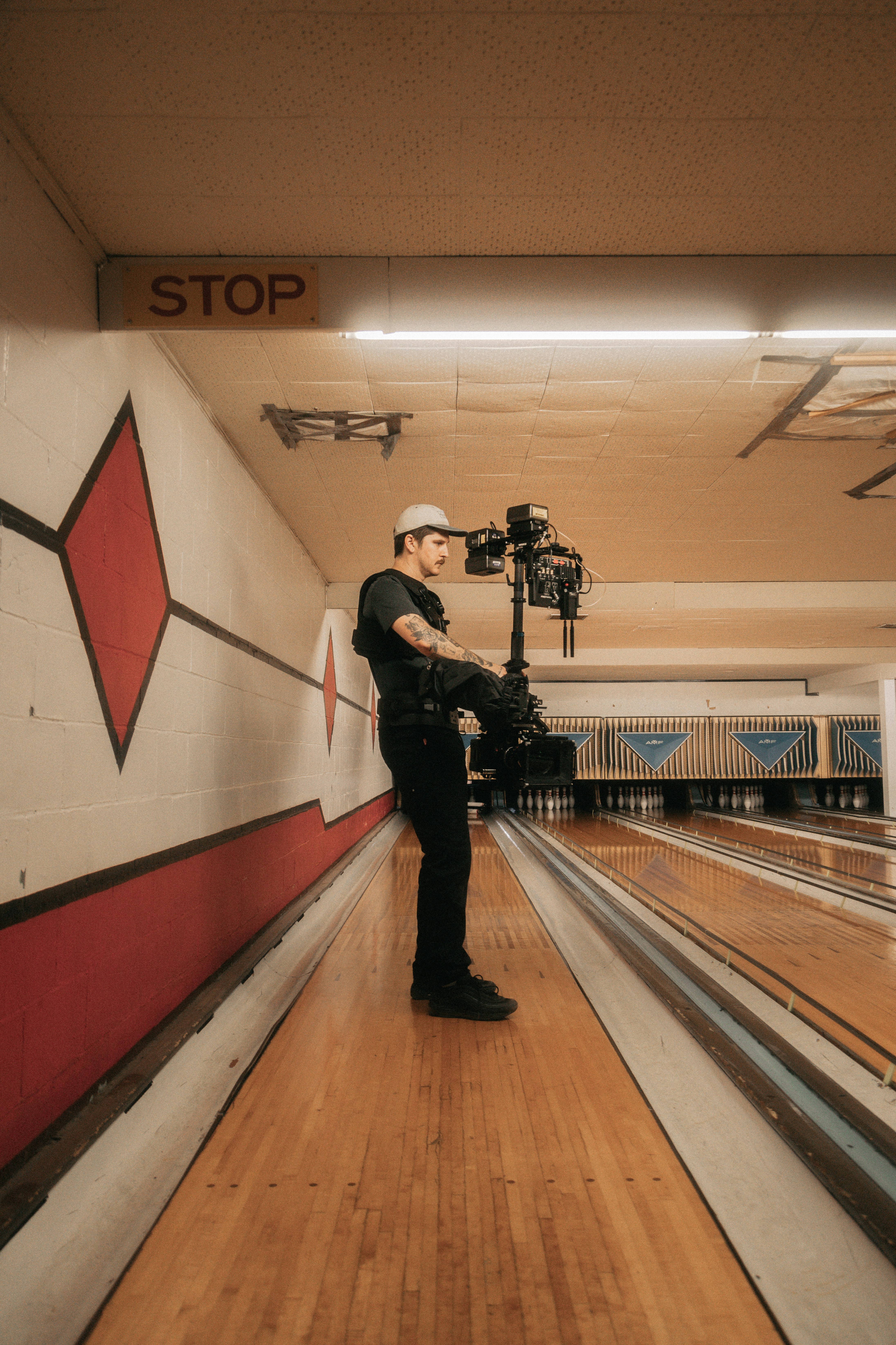 man in black jacket and black pants holding black dslr camera