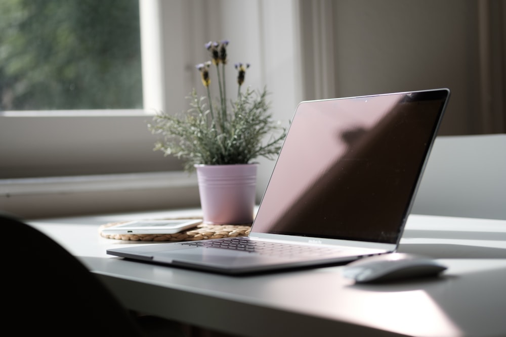 macbook air on white table