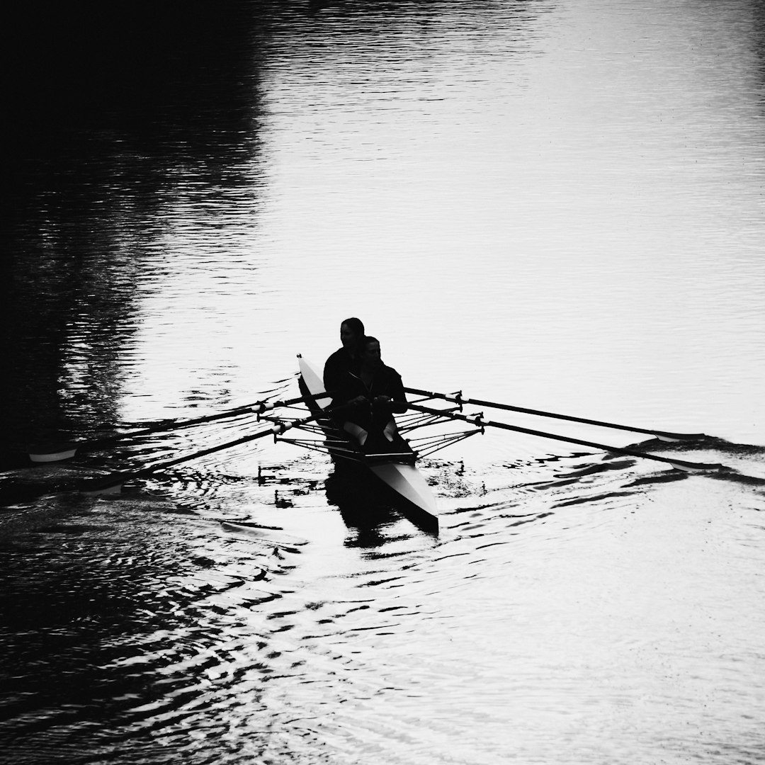 man in black shirt riding on boat on water