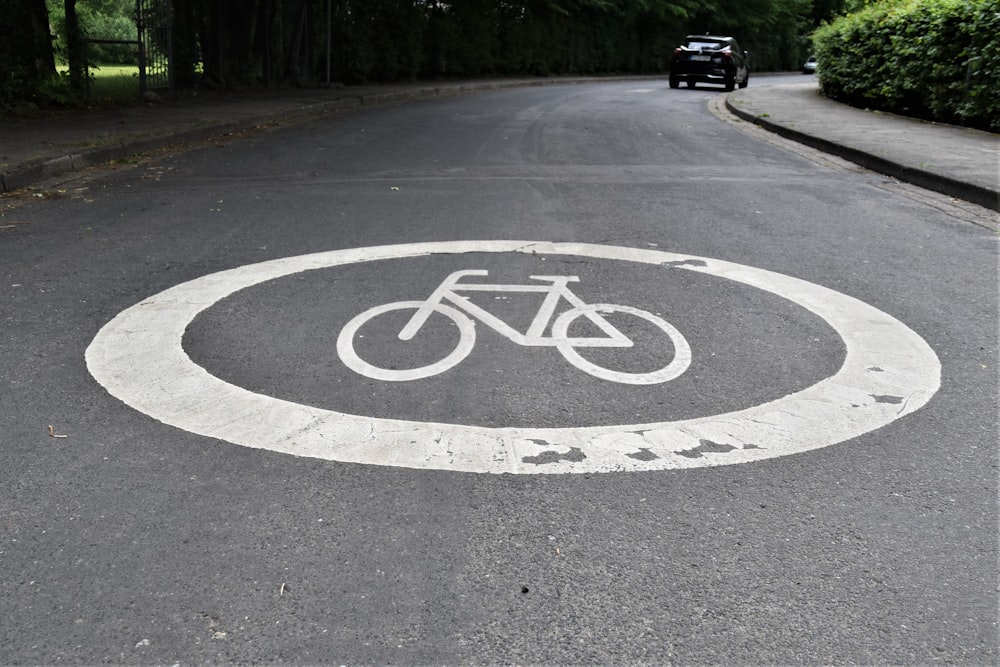 black and white round road sign