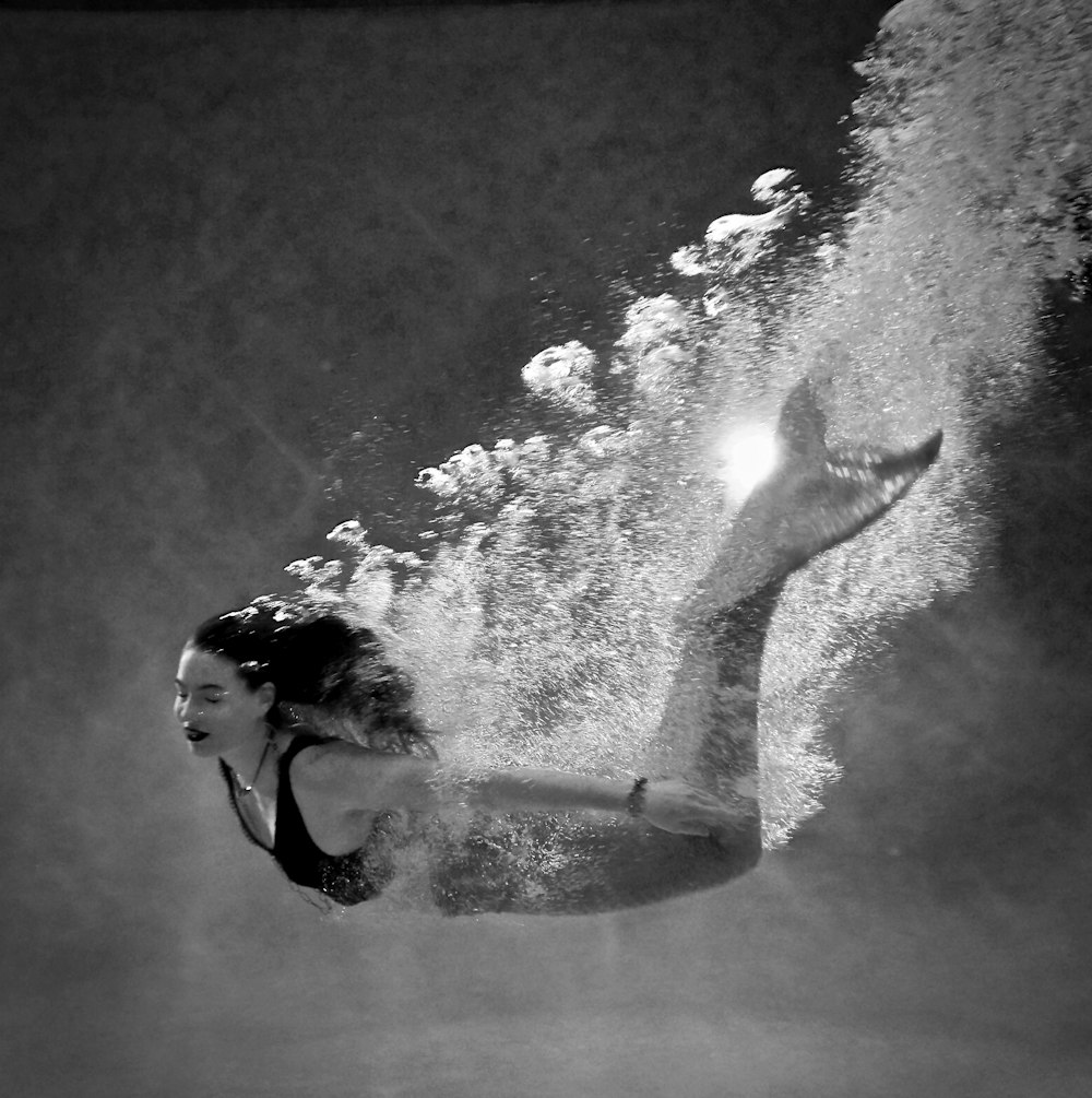 woman in black tank top and black pants in water