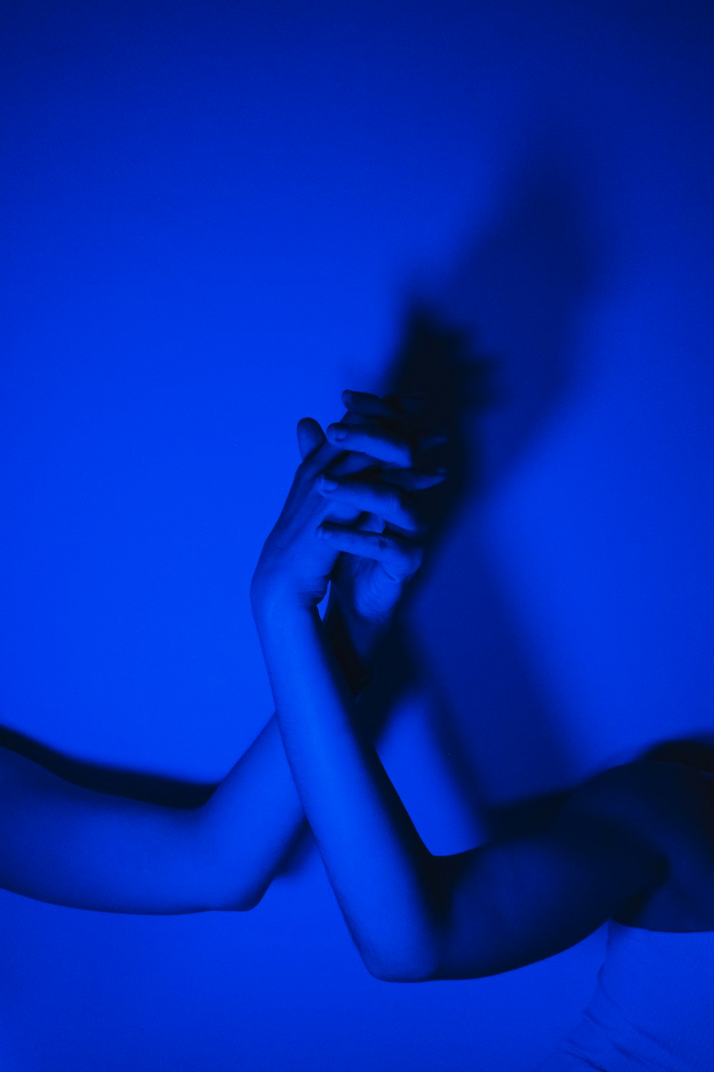 silhouette of woman covering her face with her hands