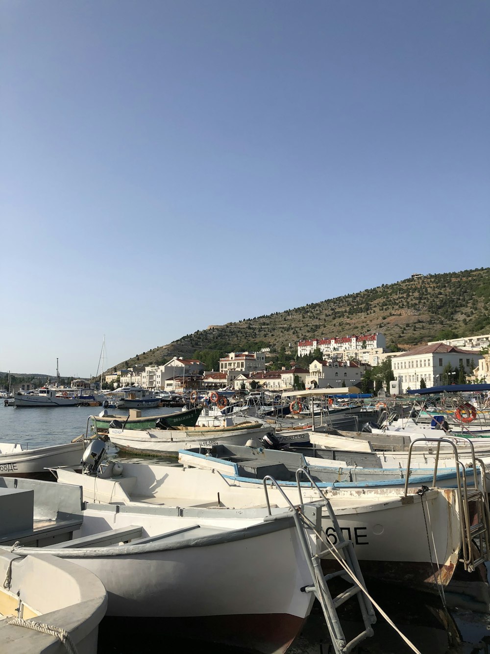 white boats on sea dock during daytime