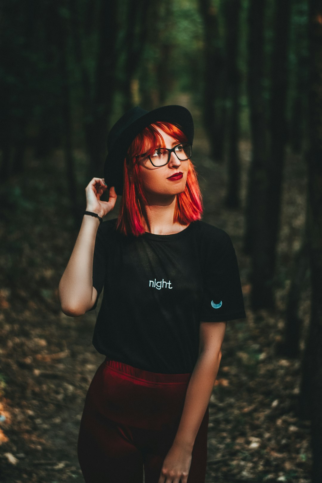 woman in black crew neck t-shirt and red shorts wearing black sunglasses