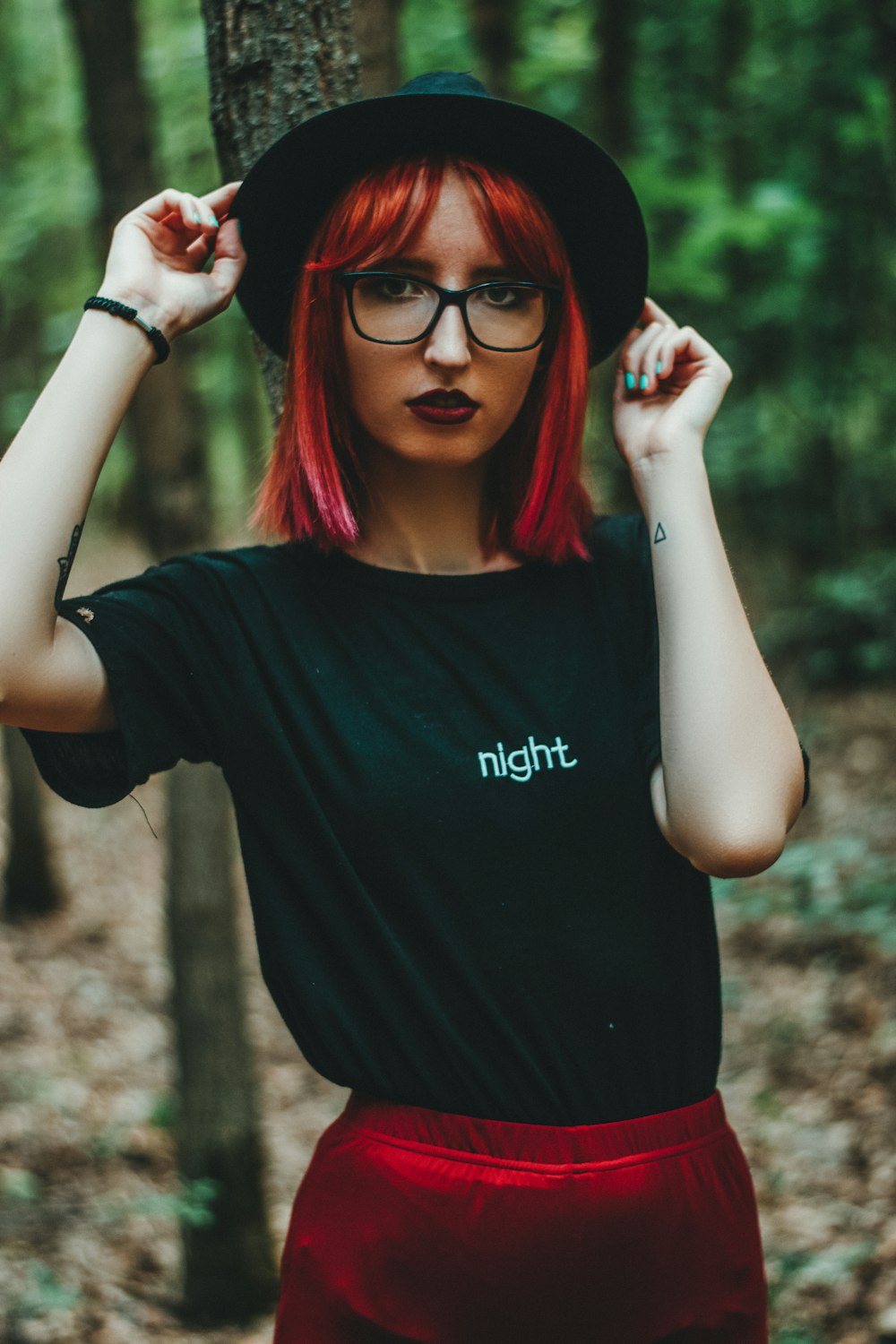 woman in black crew neck t-shirt wearing black framed eyeglasses