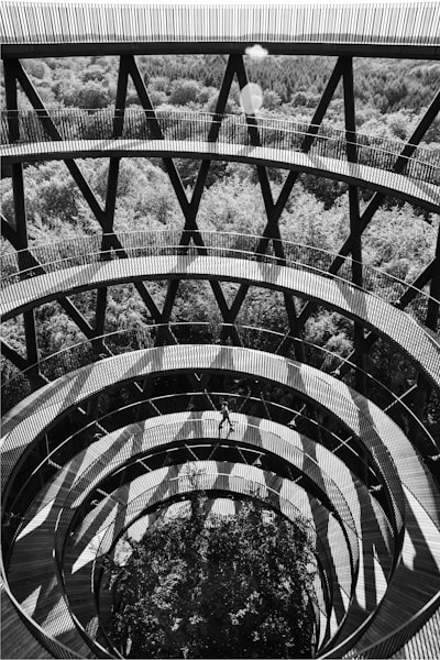 grayscale photo of spiral stairs