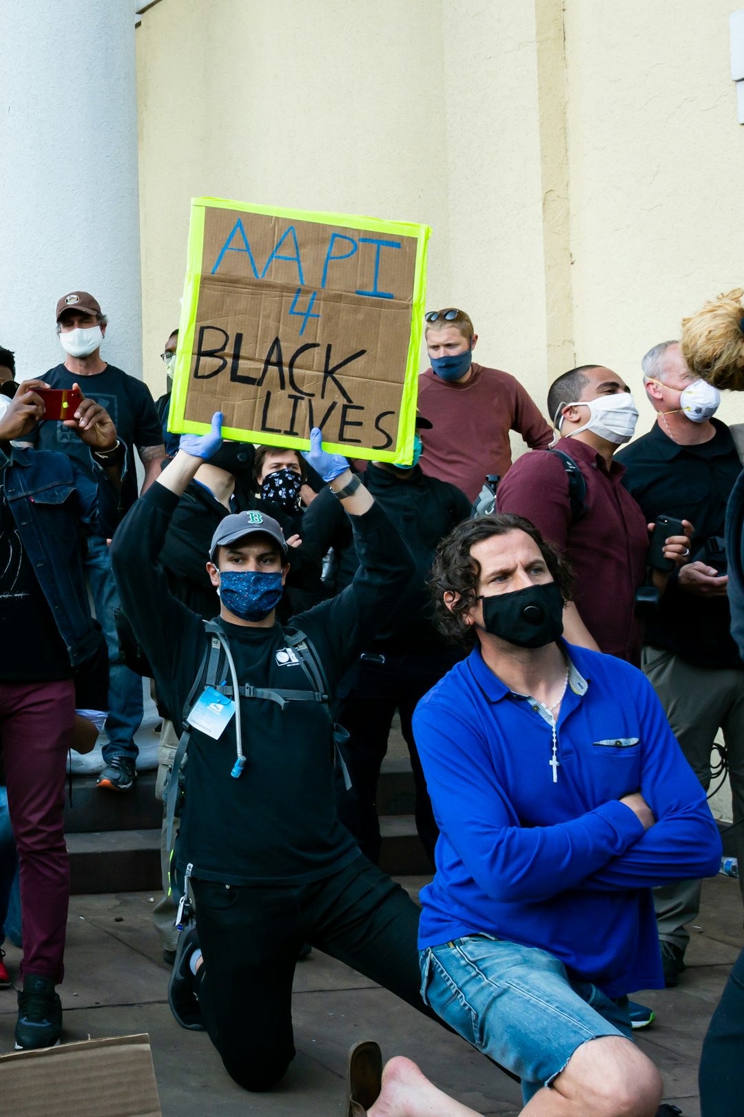 man in blue jacket wearing black sunglasses