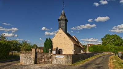 brown and gray concrete church under blue sky during daytime