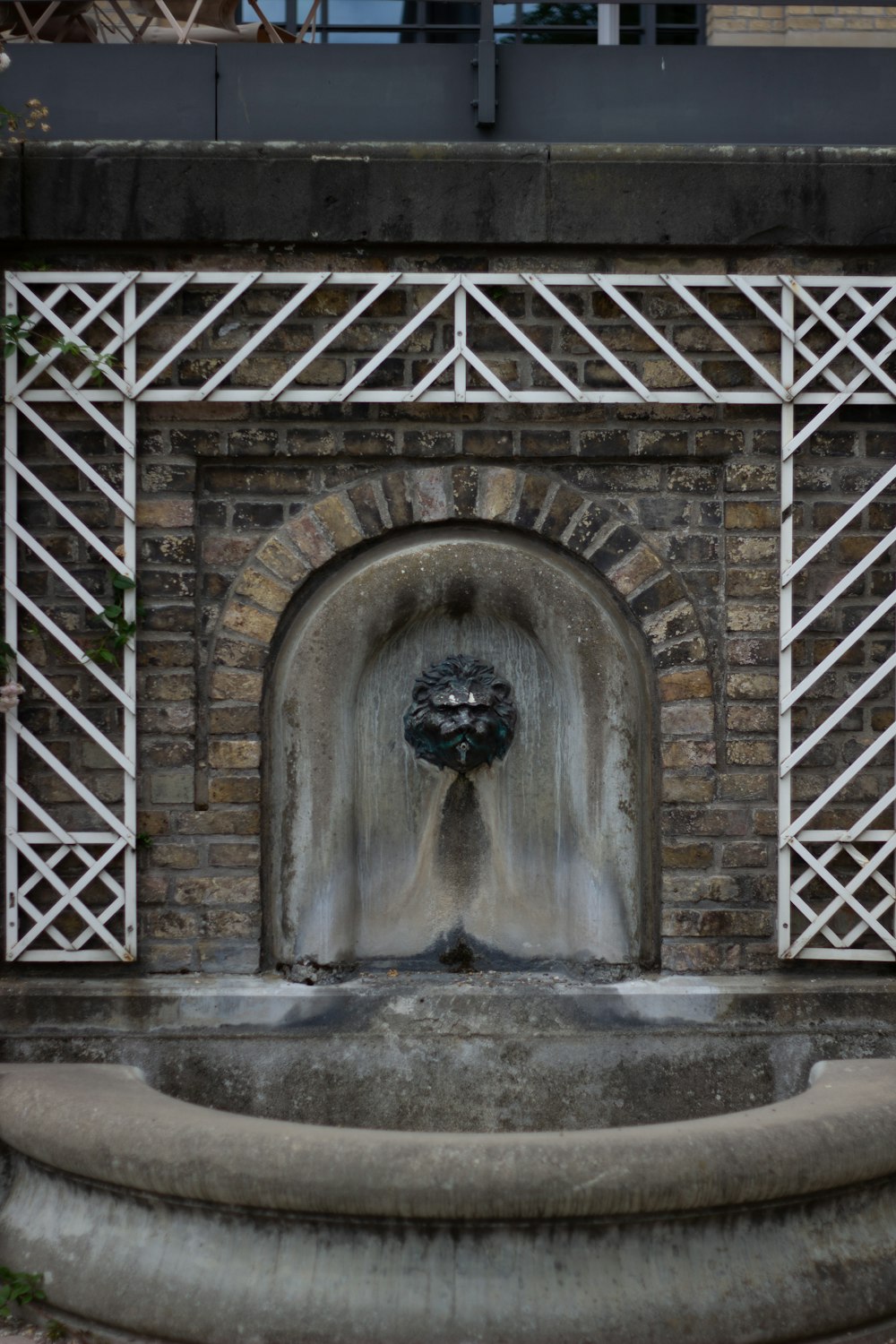 grey concrete arch with water fountain