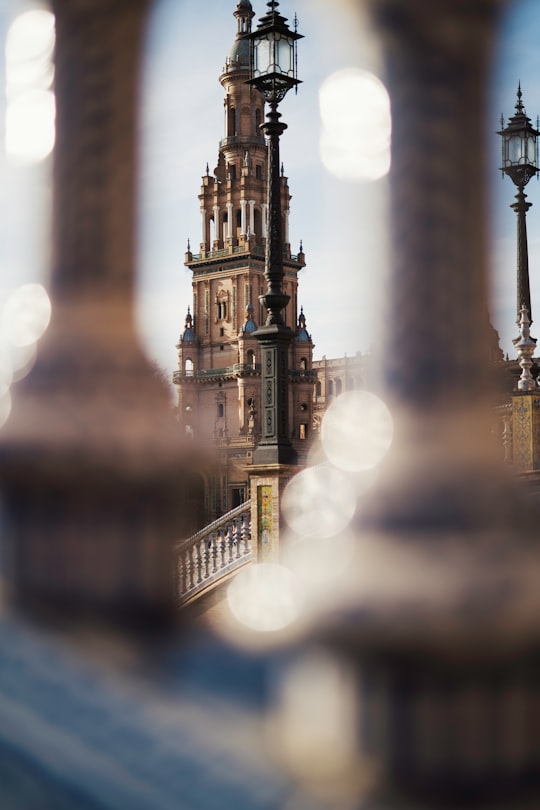 brown concrete building during night time in Plaza de España Spain