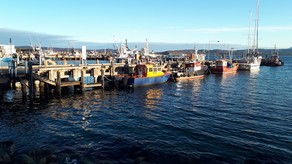 yellow and red boat on sea during daytime