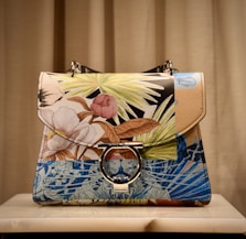 blue and brown floral leather handbag