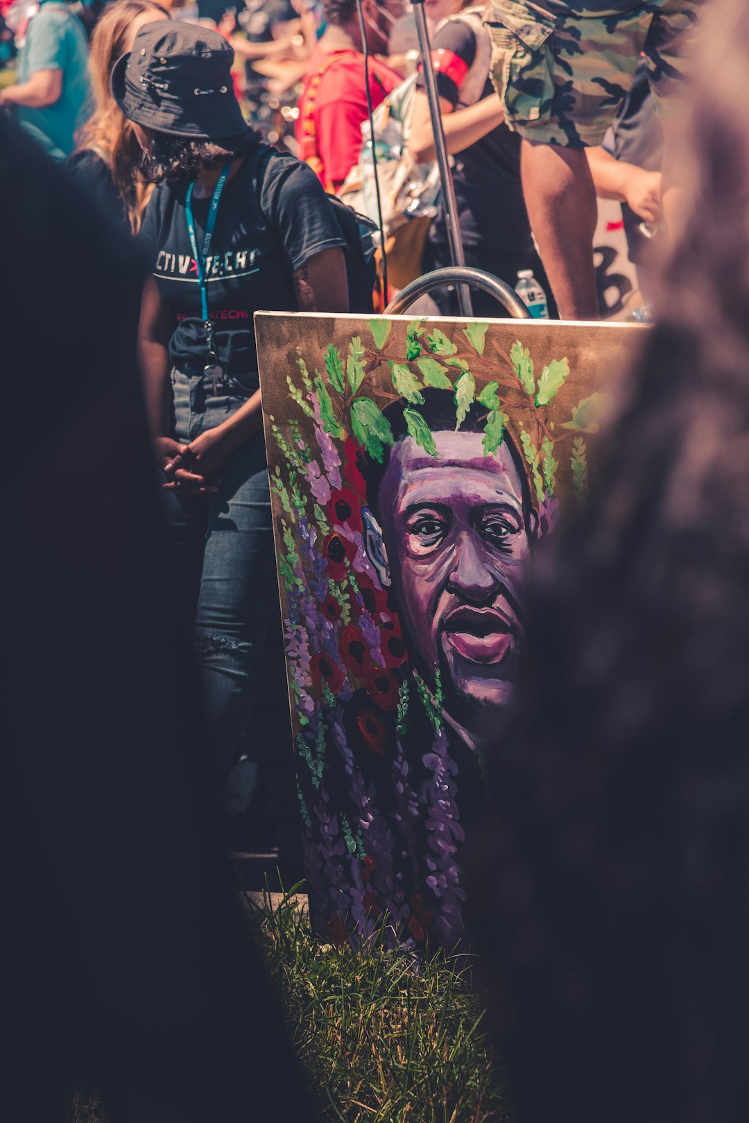 man in black t-shirt with green and red face paint