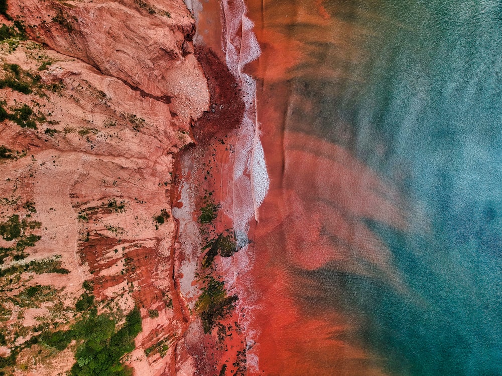 brown rock formation beside body of water