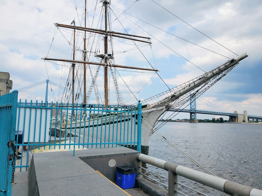 blue and white bridge over body of water during daytime