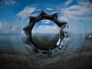 A panoramic view of the ocean horizon blending into a hexagonal pattern symbolizing precision and depth.