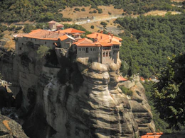 brown and white concrete building on top of mountain during daytime