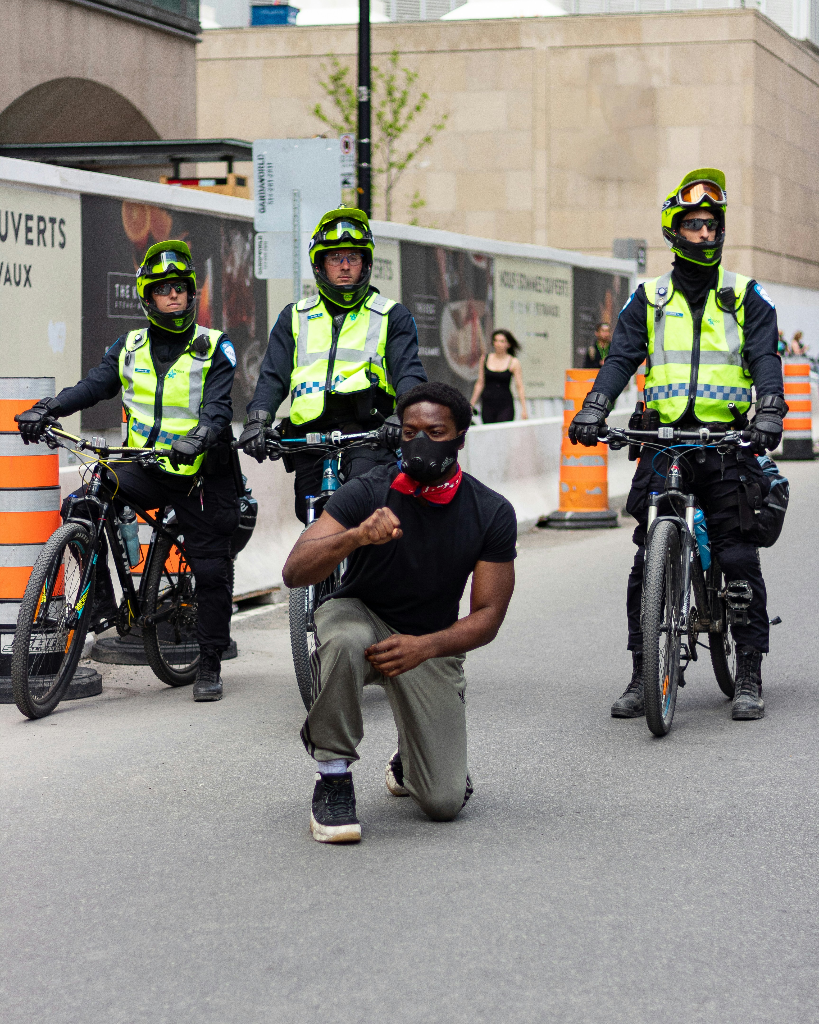 man in black t-shirt and gray pants riding on bicycle