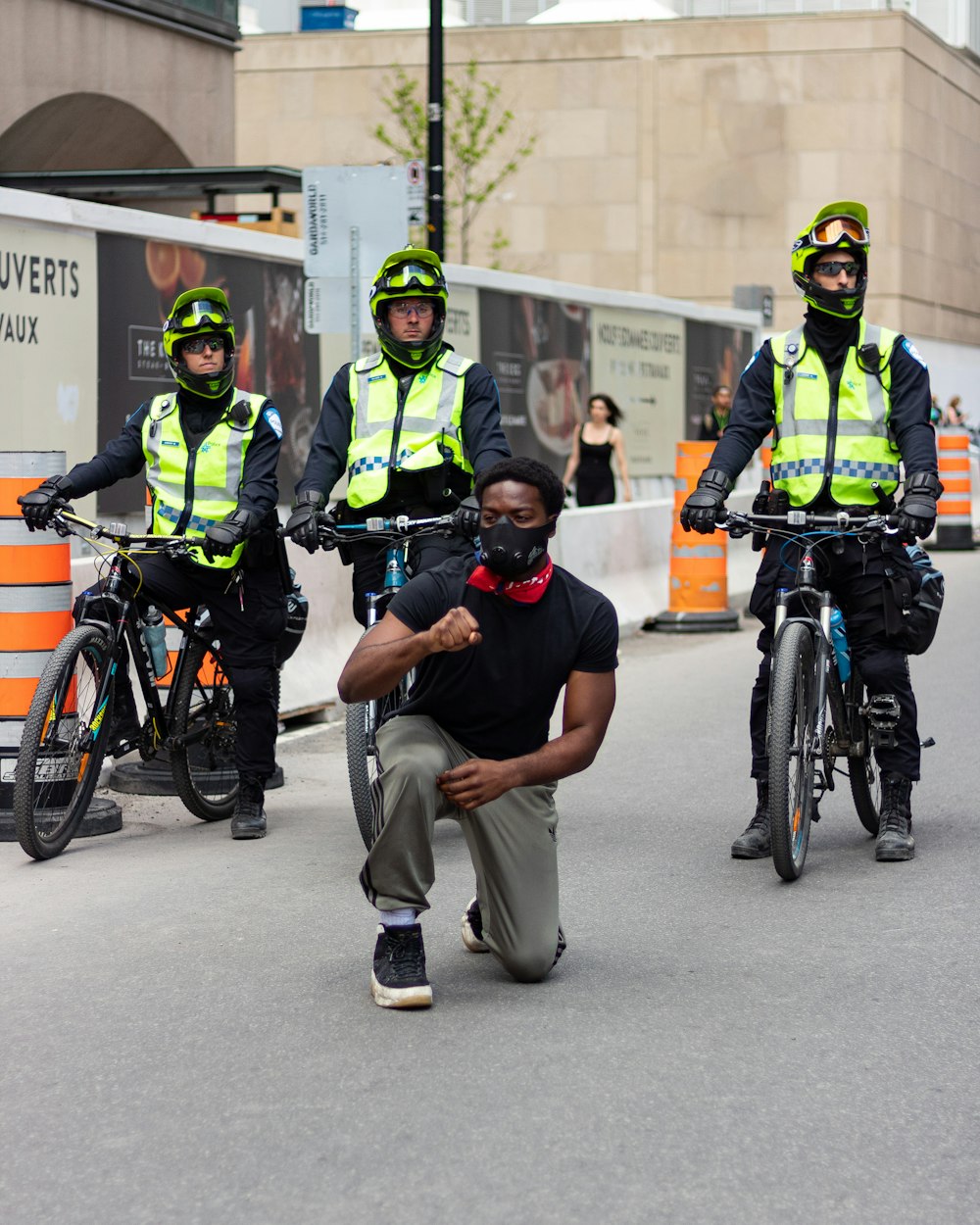 man in black t-shirt and gray pants riding on bicycle