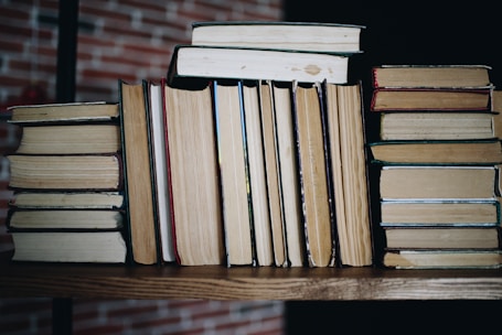 brown wooden books on brown wooden table