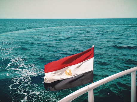 a flag on a boat in the middle of the ocean