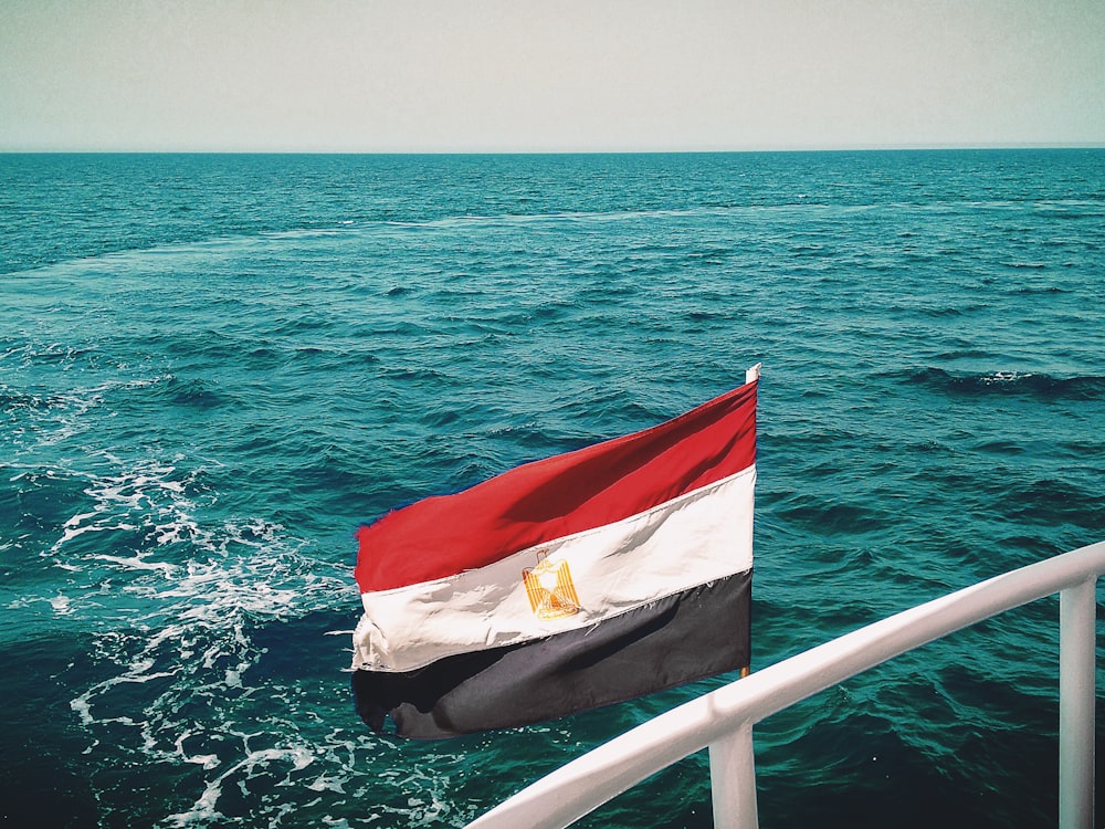 a flag on a boat in the middle of the ocean