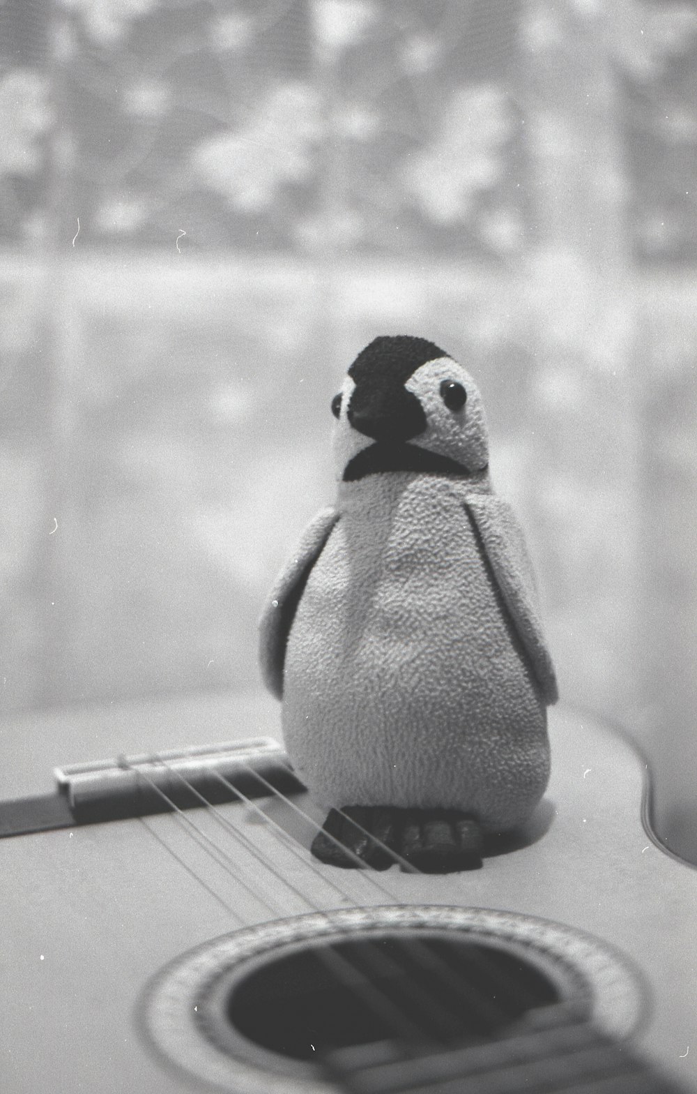 penguin figurine on black piano