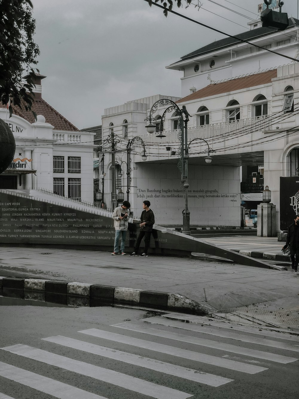 2 women walking on sidewalk during daytime