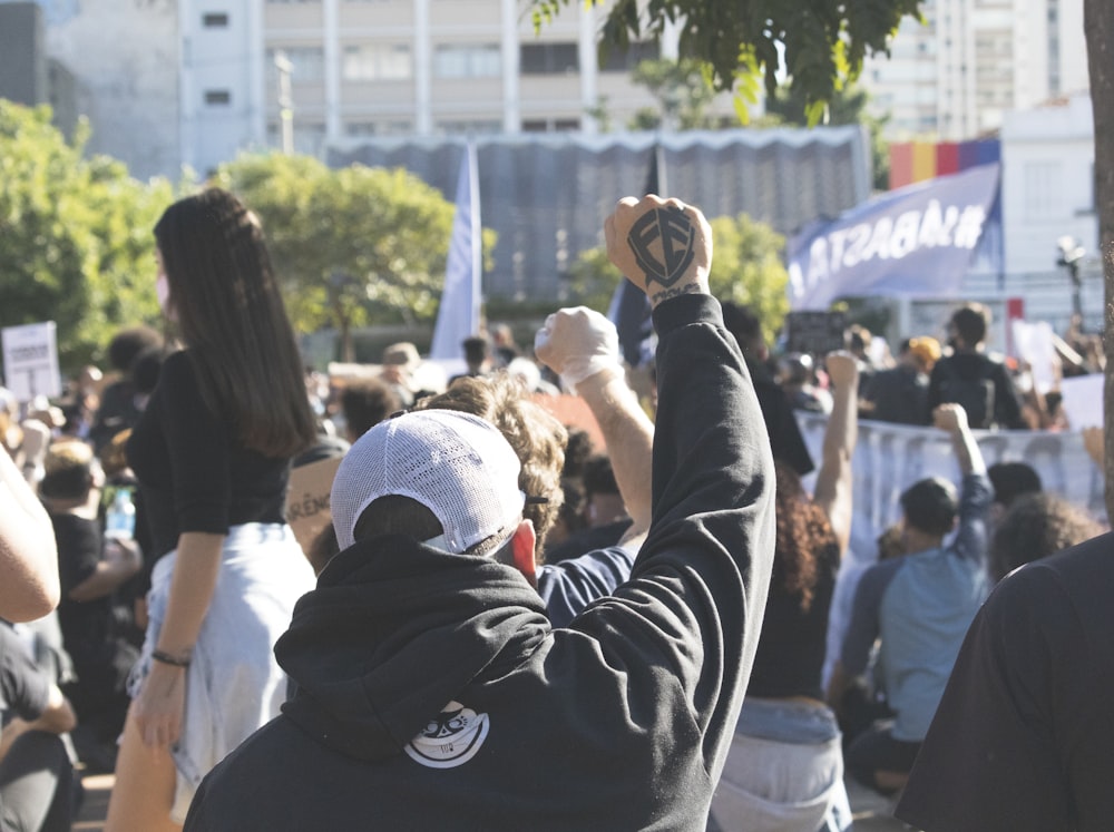 man in black jacket holding black dslr camera during daytime