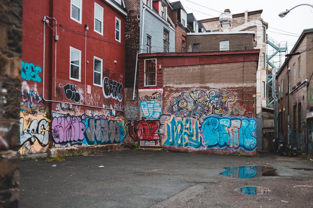 graffiti on brown brick building during daytime