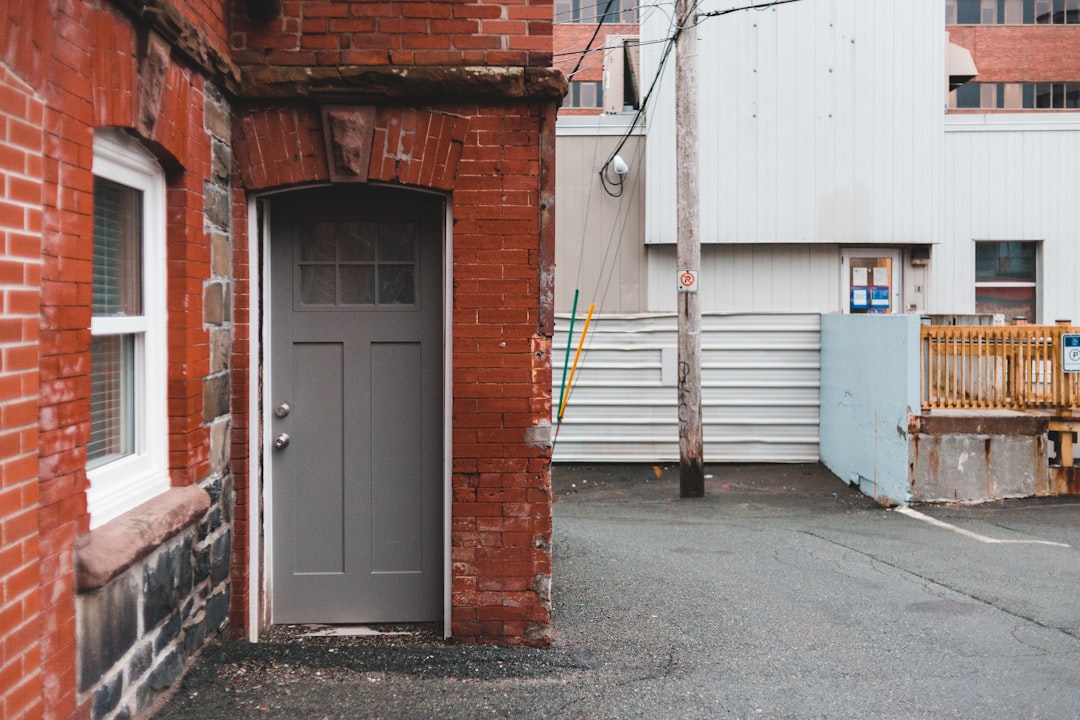 brown brick building with white wooden door