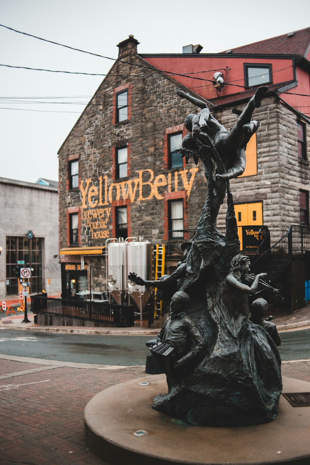 black statue of man riding horse near brown building during daytime