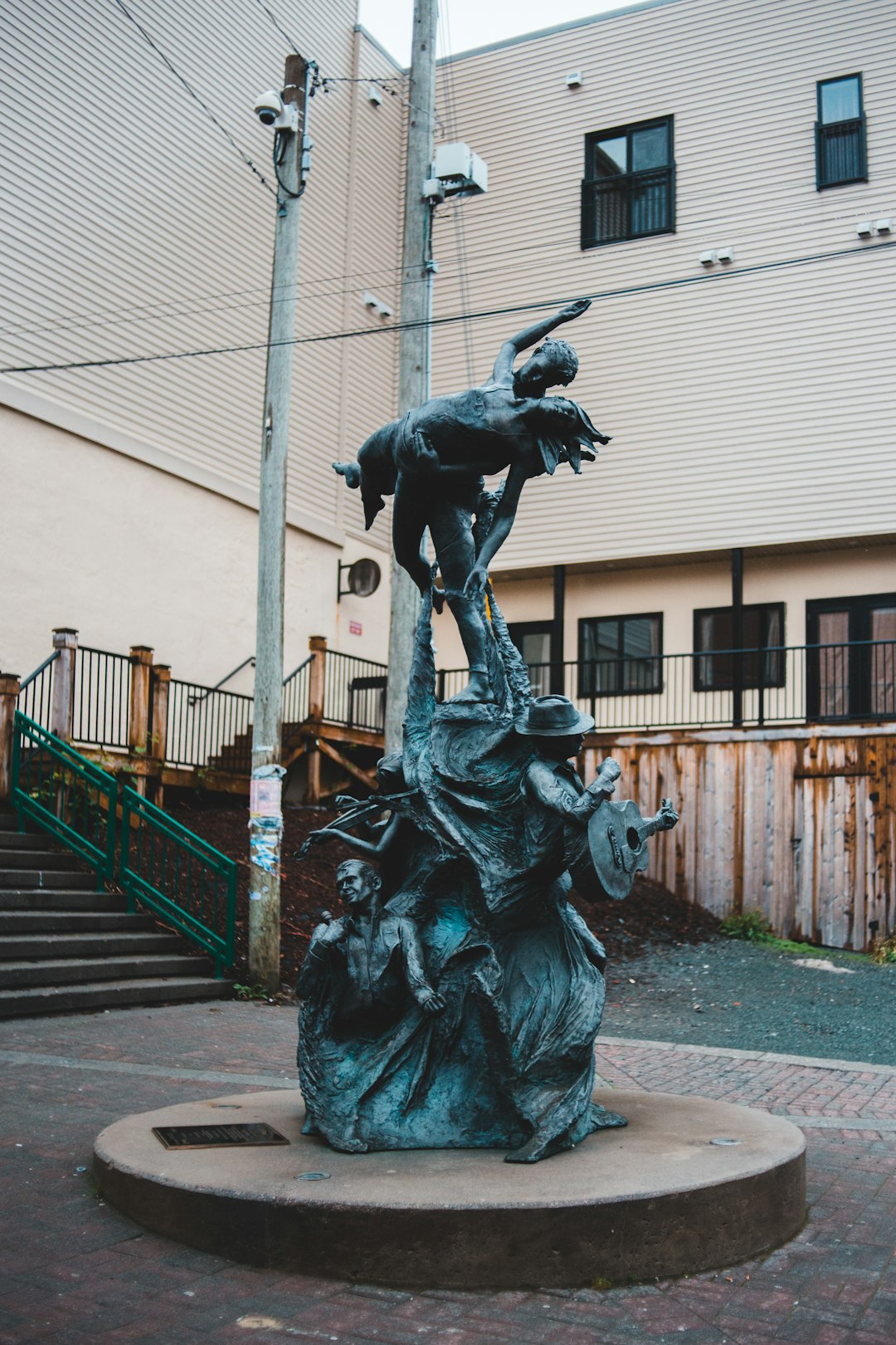 black statue of man holding book