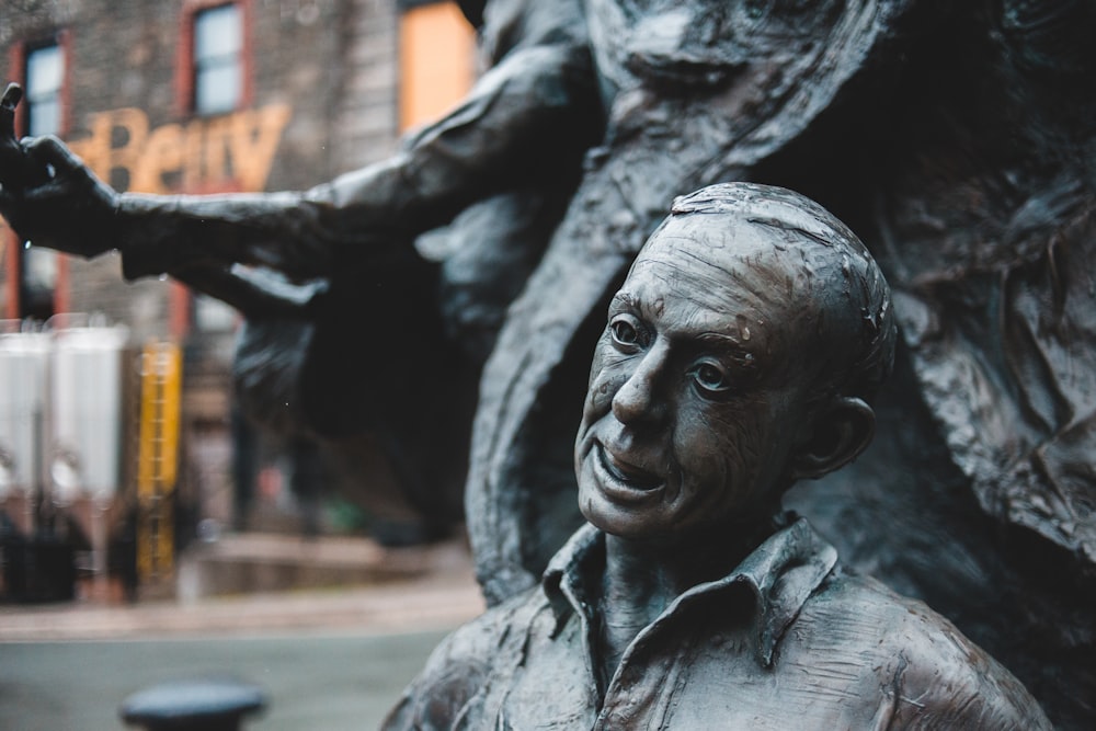 man in black leather jacket statue