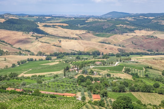 aerial view of green and brown mountains during daytime in Tuscany Italy