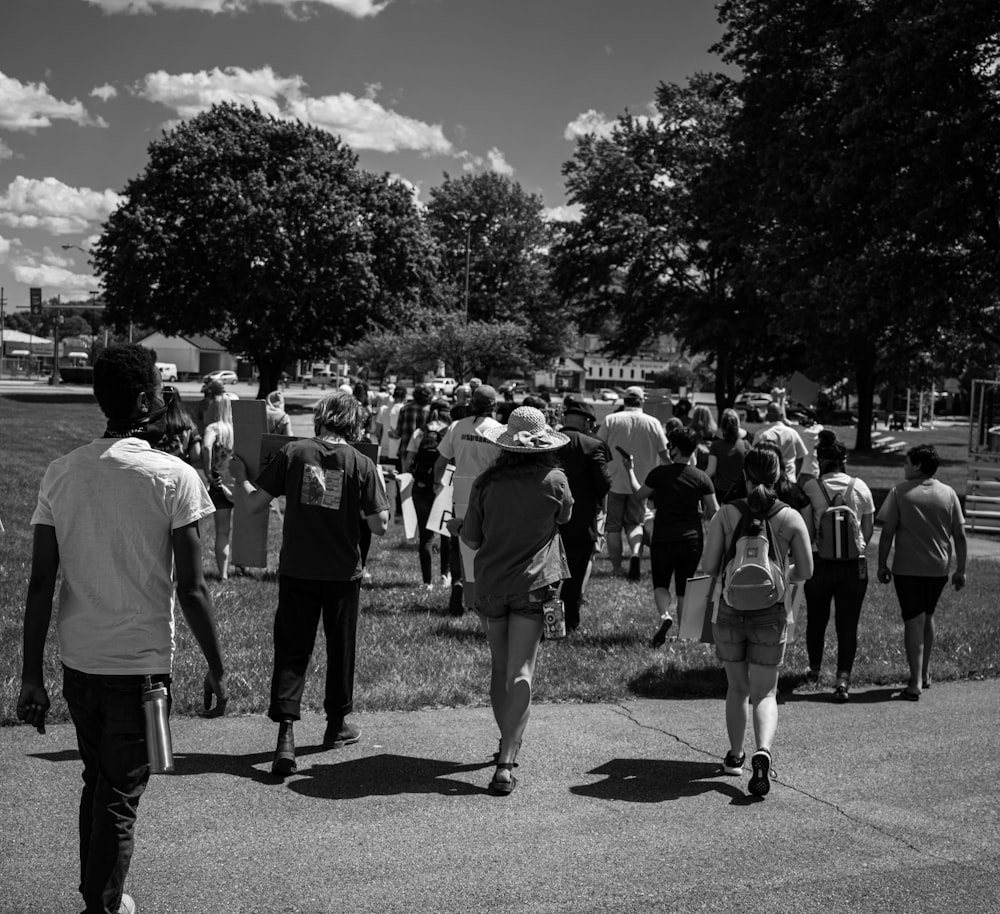 grayscale photo of people walking on street